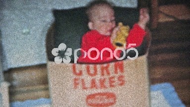 Boulder, Colorado (1951): Baby playing in Kelloggs Corn Flakes box.