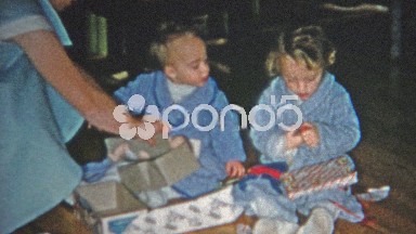 Boulder, Colorado (1952): Mom stealthily helping Christmas gift opening with