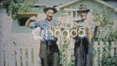 1953: Men holding a stringer of caught fish uncomfortable too long.
