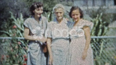 1953: Grown up daughters share a moment with senior citizen mother.