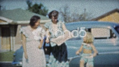 1953: Mom Reading Newspaper Helping Baby and Aunt Walking