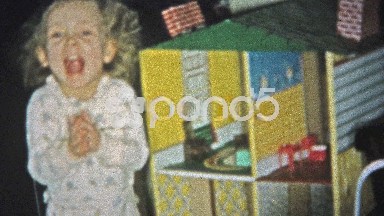 1957: Rich Girl Smiling While Playing with Oversized Dollhouse