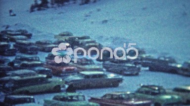 1967: Ski resort parking lot cars skis laid out everywhere.