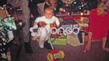 1968: Baby first steps help from mother father mowing toy.