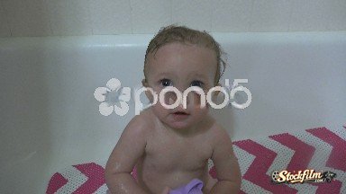 Denver, Colorado, United States: Happy baby taking a bath showing off splash cup toy.