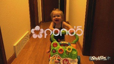 Denver, Colorado, United States: Baby Learning to Stand Using Toy Walker Chase Down Hall.