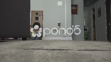Sneaky baby hiding behind couch comes out to play.