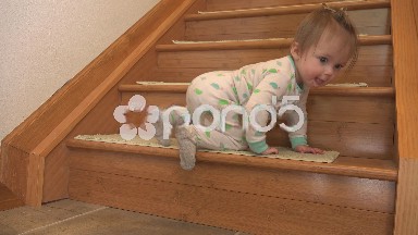 Baby's first stair climb in cute pajamas.