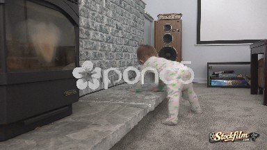 Denver, Colorado, United States: Baby showing off cruising along fireplace mantle in family room.