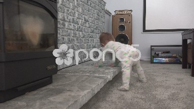 Baby showing off cruising along fireplace mantle in family room.