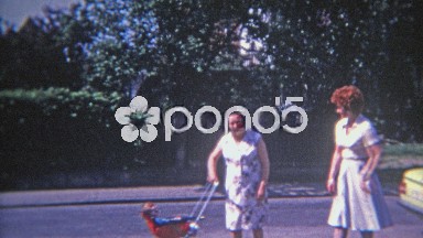 1973: Fashionable French Canadian Mom Taking Baby from Old Nanny
