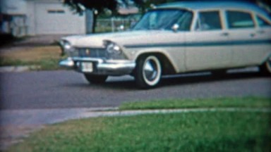1957: Proud mom and son pull up in new 57' Plymouth car.