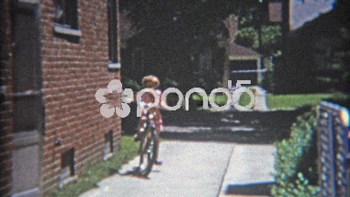 1953: Girl Riding Bike Aggressively in Suburban Driveway