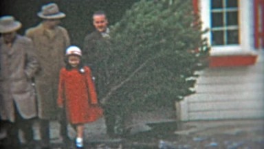 1953: Dad shows off this years Christmas tree with family.