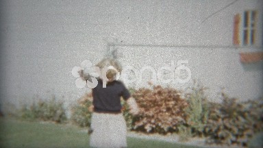 1953: Young girl playing outdoors with Yo Yo toy.