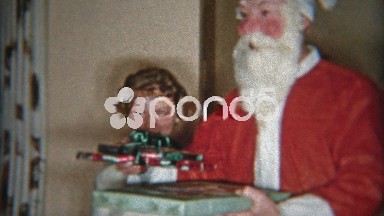 1953: Creepiest Santa Claus mask ever giving gifts to family.