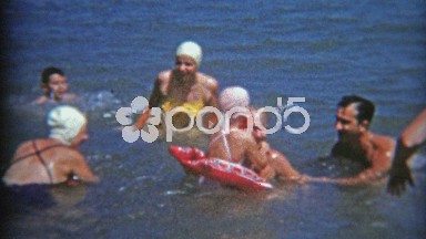 1953: Ladies all having swim caps when at the beach.