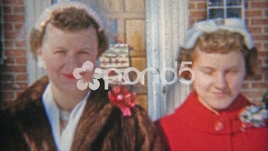 1957: Family leaving house for church Christmas mourning.