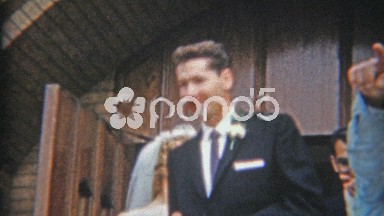 1957: Newlywed couple leaving church kissing and celebration.