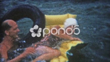 1956: Man Attempts to Flip Women from Raft on Lake in Flint, Michigan