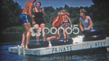 1956: Private swimming dock summer fun has kid ultra excited.
