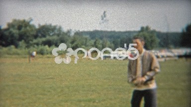 1956: Father and Son Play Catch with Baseball in Public Park