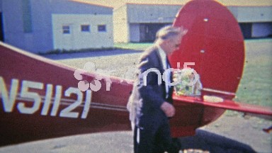 1965: Executive and Pilot Preparing Private Plane for Short Flight