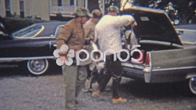 1973: Men Splitting Goose Hunt Bounty in 1970s Truck Near Classic Car