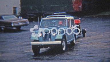 1972: 6 wheel amphibious all terrain vehicle being towed.