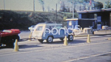 1972: Jeep towing 6-wheel ATV past border crossing.