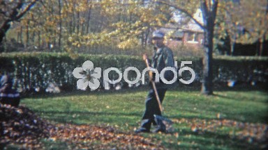 1967: Man Raking Autumn Leaves as Kid Plays in Pile