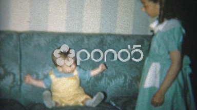 1951: Big sister and brother posing with the new baby.