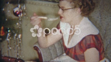 1954: Redhead glasses girl eating cake and offering to young child.