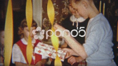 1954: Boy opens Christmas gift of moccasin shoes.