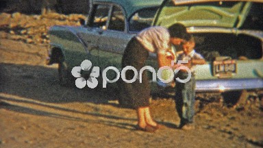 1954: Mom brushing dirt off of dirty little boy.