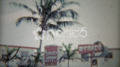 1959: Exterior shots of the Monaco hotel and parking lot of old cars.