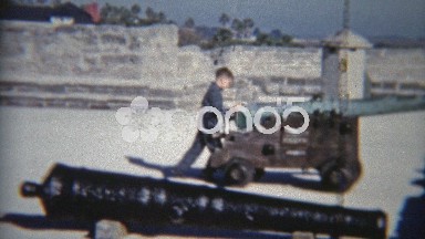 1959: Child playing with cannons at old military fort museum.