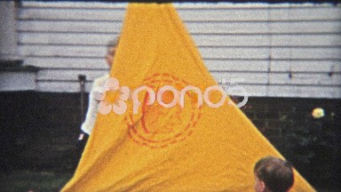 1954: Setting up boy scout tent in backyard as a dry run for real camping.