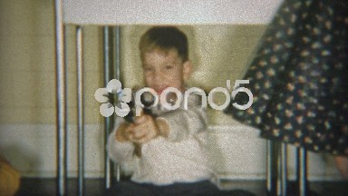1954: Boy recklessly pointing toy guns and bossing around playmate.