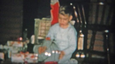 1954: Boy Putting on Clear Astronaut Space Explorer Helmet Christmas Gift