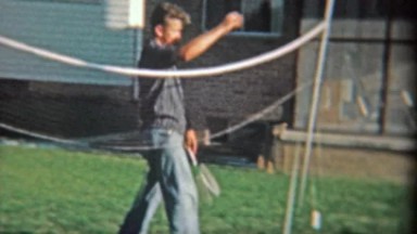 1954: Badminton Player Tricks Loser in Playful Handshake Prank