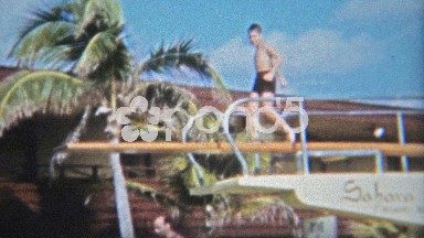 1962: Boy chickening out off the high hotel diving board and choosing the kiddie