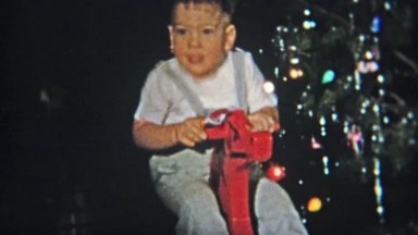 1953: Cute Boy on Christmas Red Rocking Horse Gift.