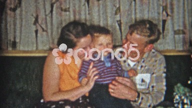 1961: Pocket Protector Dad and Mom Playing with New Baby at Christmas