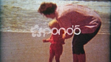 1961: Kids 1st time at beach boy scared of ocean waves.