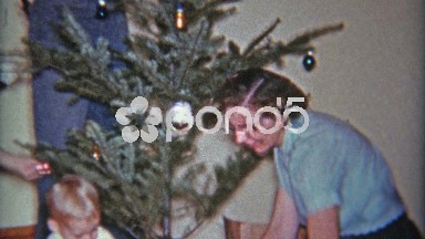 1961: Decorating a sad charlie brown style Christmas tree in a coffee can.