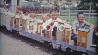 1961: Children on mini train circling at local amusement park.