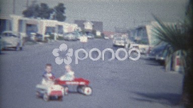 1962: Kids in Kiddie Car and Wagons Pulled Around Trailer Home Park