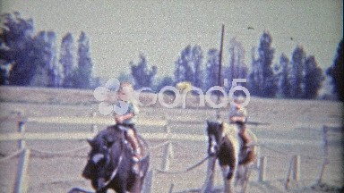 1962: Boys riding horses for 1st time smile and wave hello.