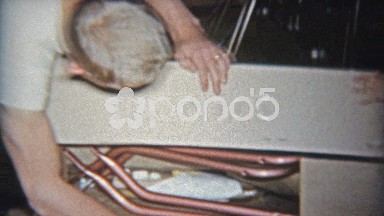 1962: Dad and toddler son building toy rocking horse together from box kit.